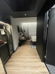 a room with a bed and a black door