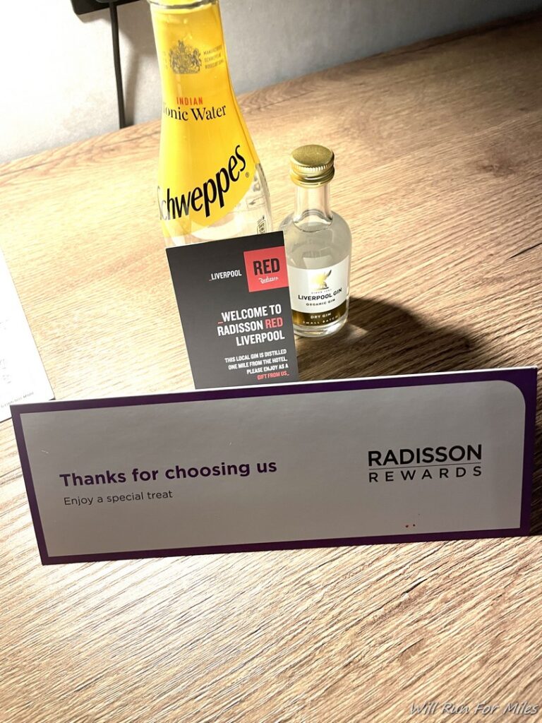 a bottle of liquid and a sign on a table