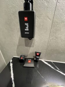 a soap dispenser and small bottles on a counter