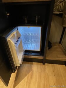 a small refrigerator with a door open