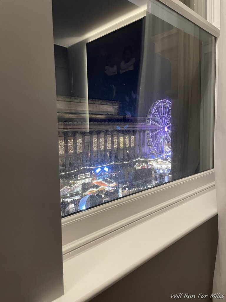 a window with a ferris wheel in the background