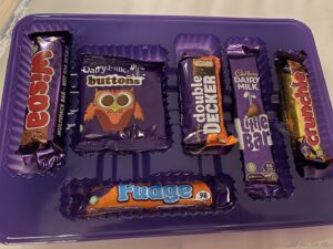 a purple tray with different types of candy bars
