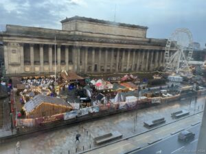 a large building with a ferris wheel and a large building with a ferris wheel