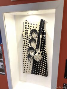 a dress with a guitar on a wall