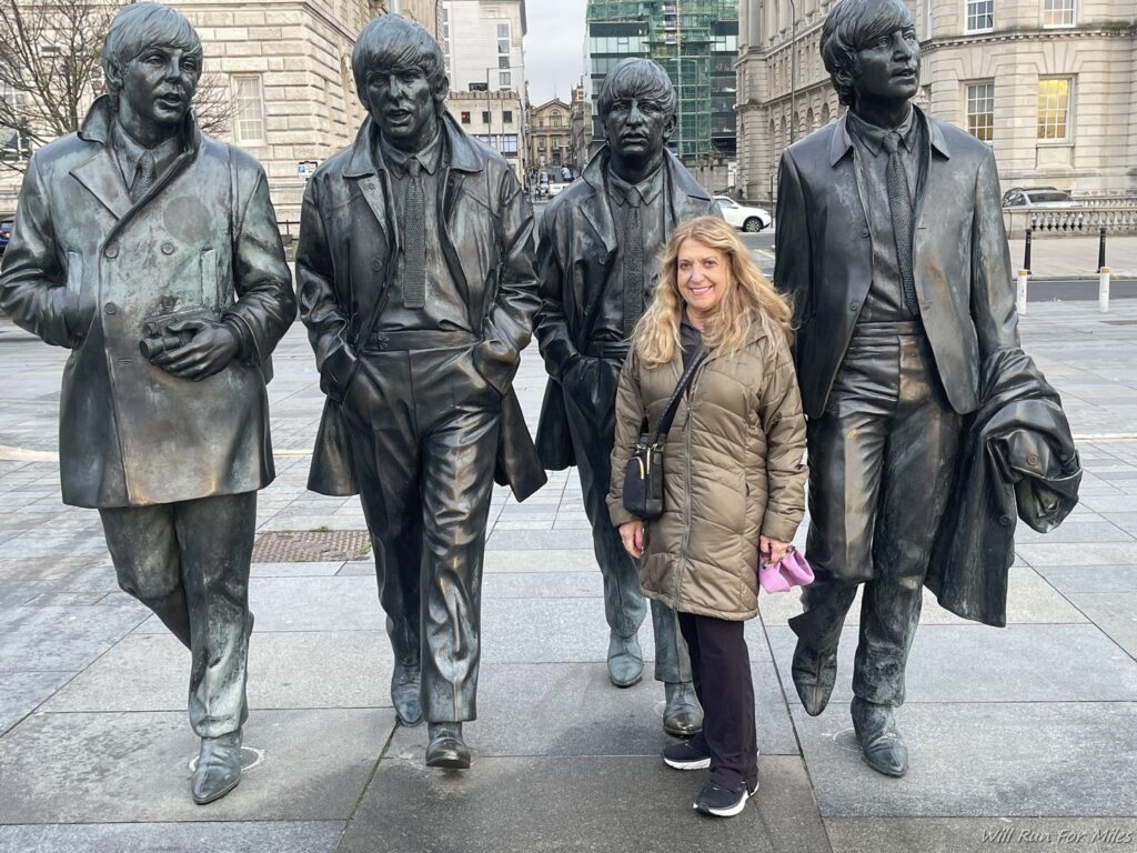 a woman standing in front of a group of statues
