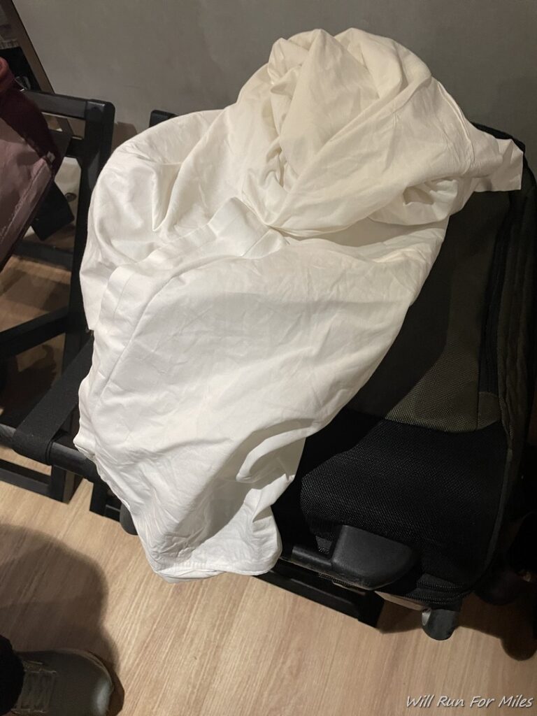 a white blanket on a chair