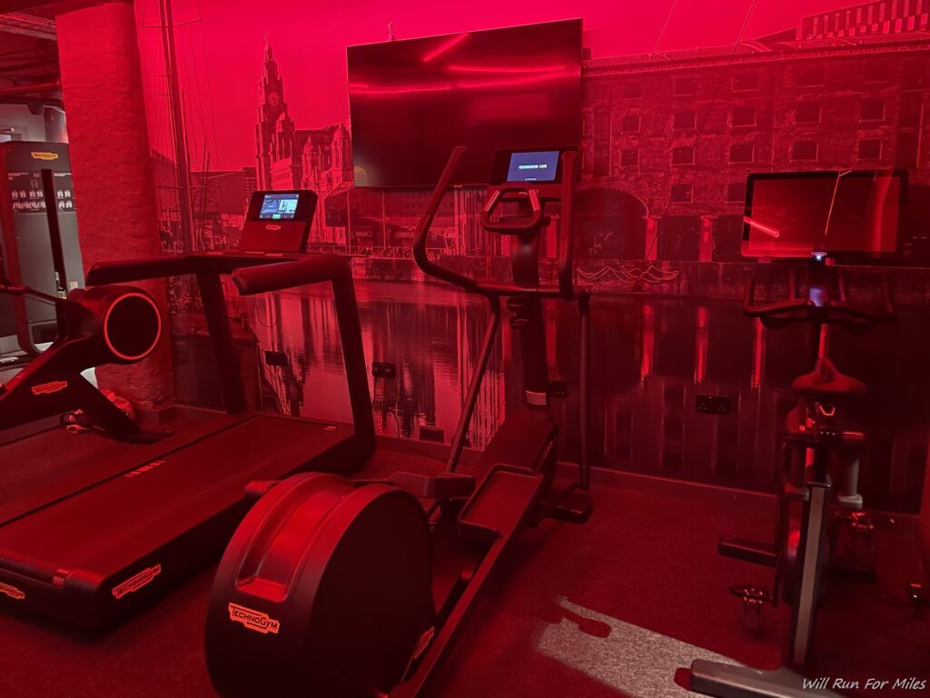 a gym with treadmills and monitors