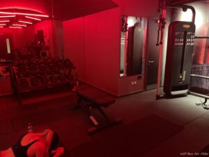 a woman lying on the floor in a gym
