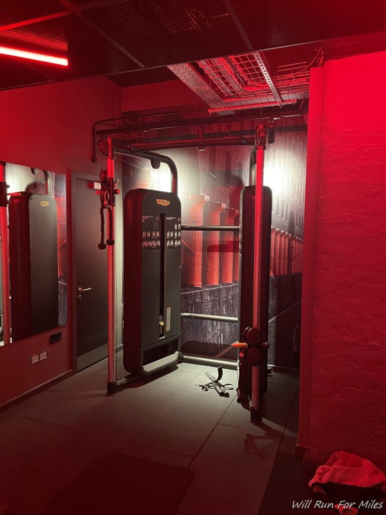 a gym room with a mirror and a machine