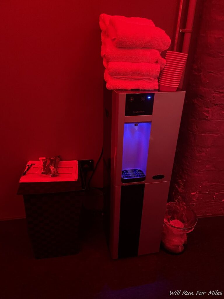 a water cooler with towels stacked on top