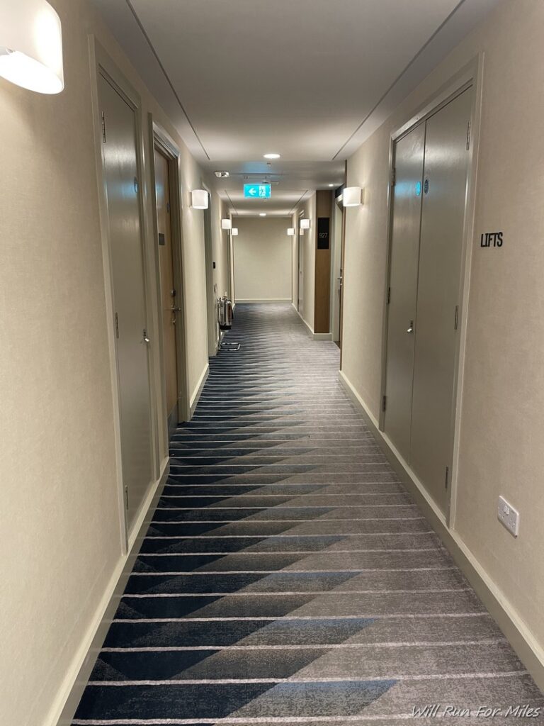 a hallway with doors and a carpet