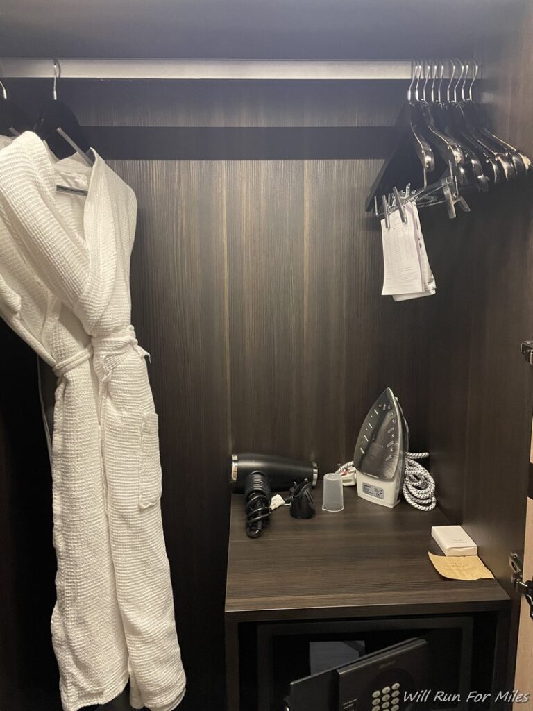 a white robe on a swinger in a closet