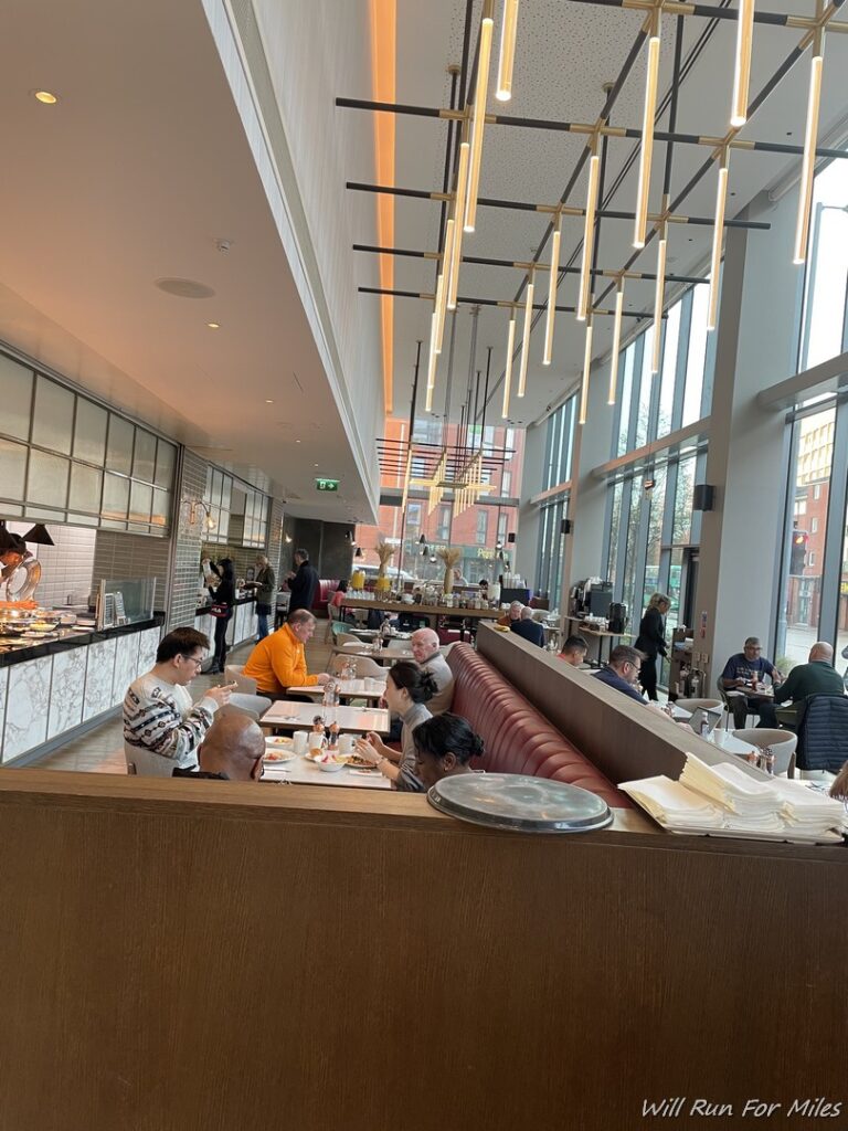 a group of people sitting at tables in a restaurant