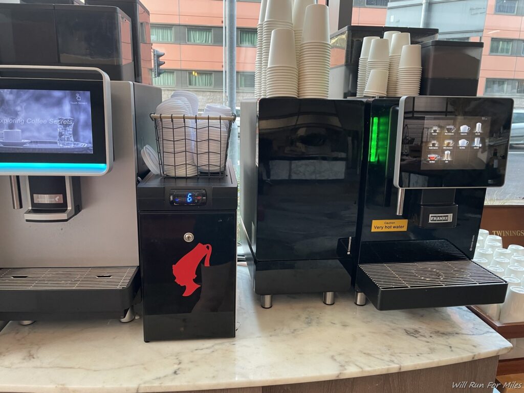 a coffee machine and dispenser on a counter