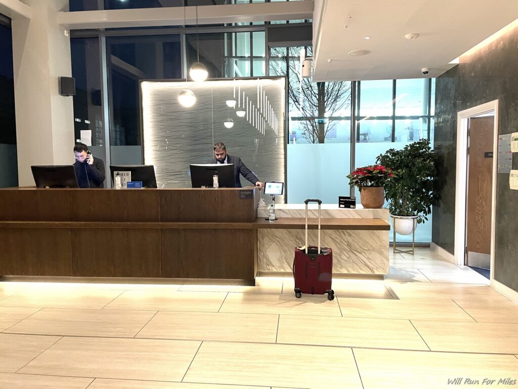 a man standing at a desk in a hotel