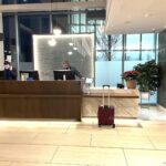 a man standing at a desk in a hotel