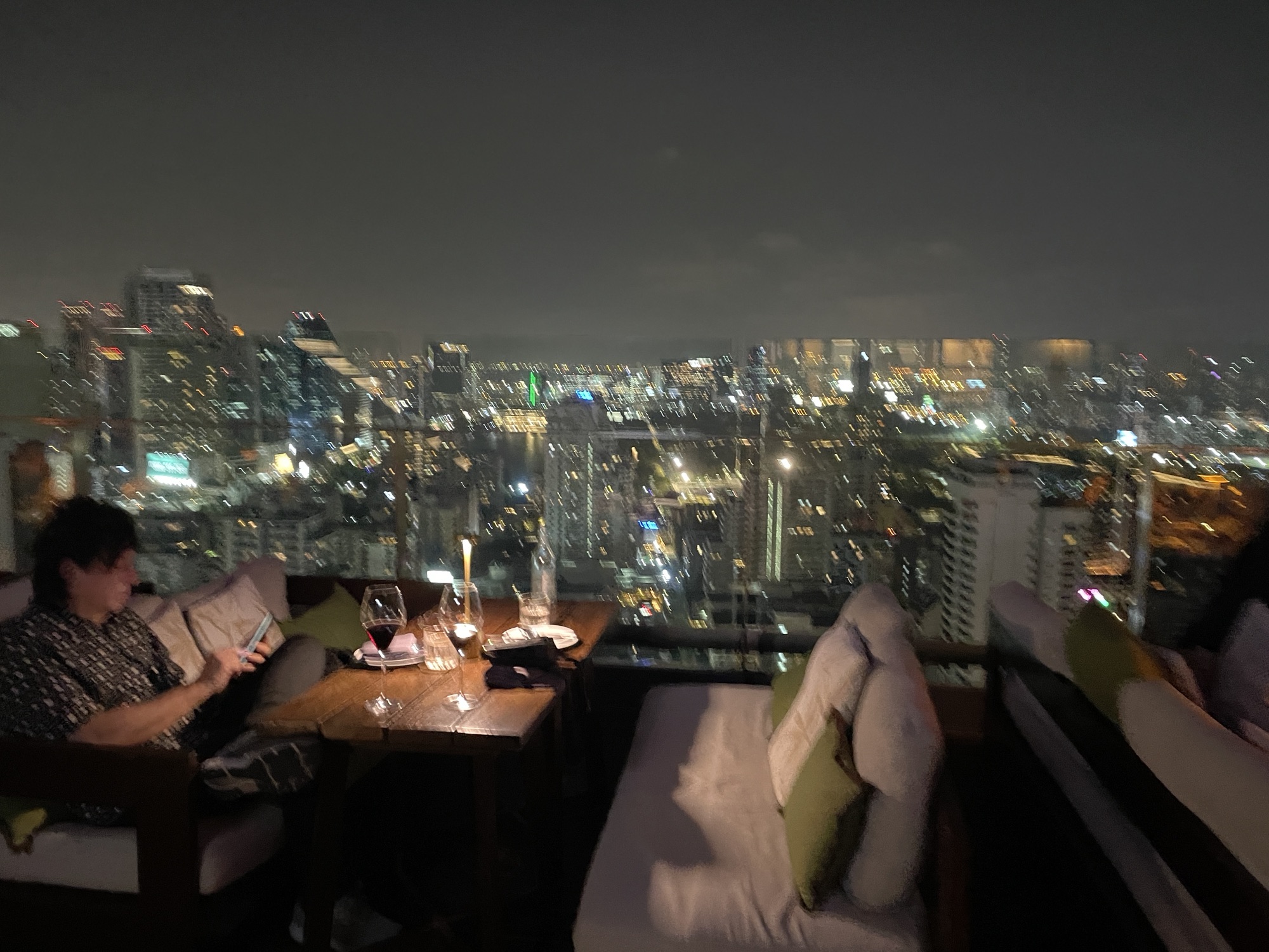 a rooftop restaurant with a view of a city