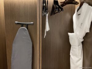 a ironing board and clothes on a wall