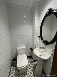 a bathroom with a mirror and toilet
