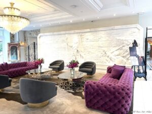 a room with purple couches and chairs