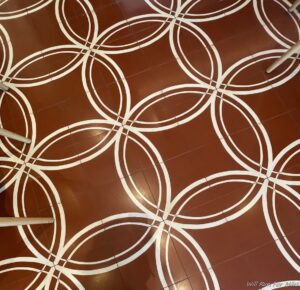 a red and white tile floor with white circles on it