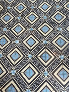 a floor with black and white tiles