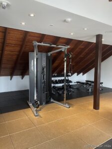a gym with a machine and weights in the ceiling