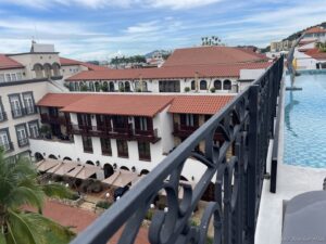 a pool and buildings with a fence