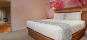 a bed with a pink wall and a pink wall