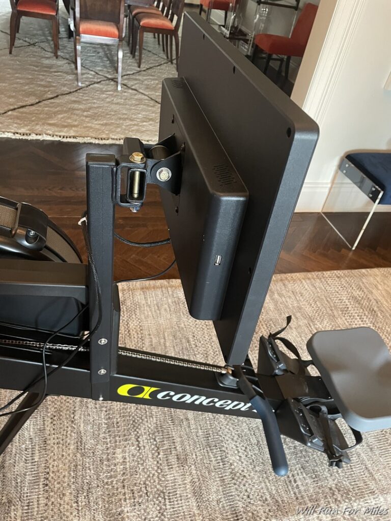 a black exercise bike with a monitor on it