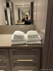 a woman taking a selfie in a bathroom mirror