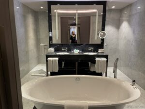 a bathroom with a large mirror and a tub