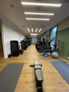 a room with exercise equipment and a bench