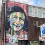 a mural of a girl on a building