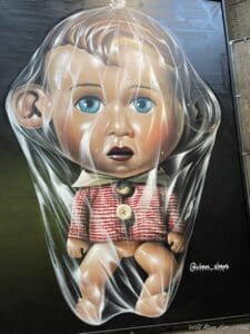 a painting of a baby wrapped in plastic
