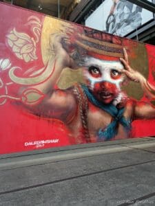 a mural of a woman with a hat on a wall