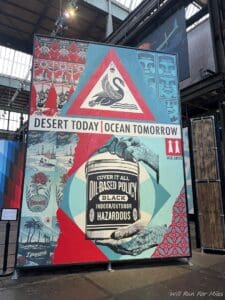a large sign with a bird and a red triangle