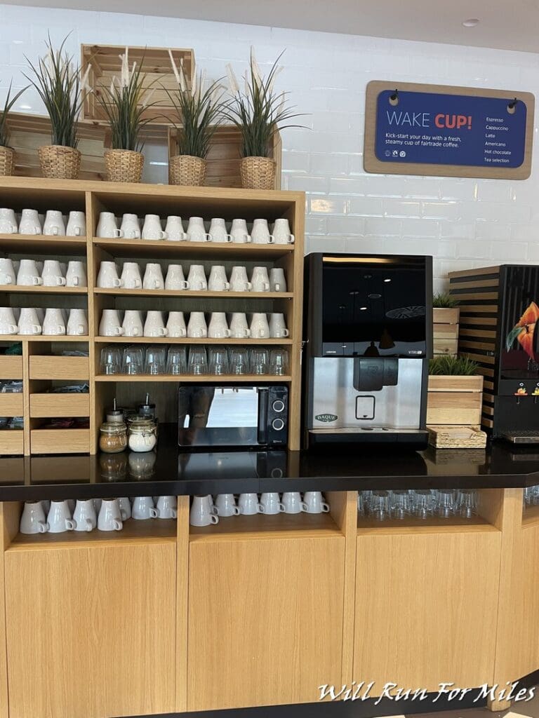a coffee machine and cups on shelves