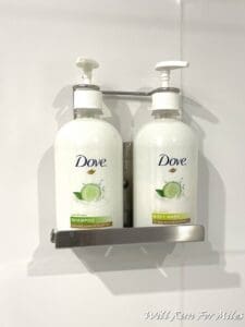 a group of white bottles on a metal shelf