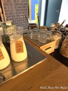 a table with a tray of cereals and milk