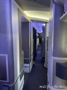 a hallway with a door and a shelf