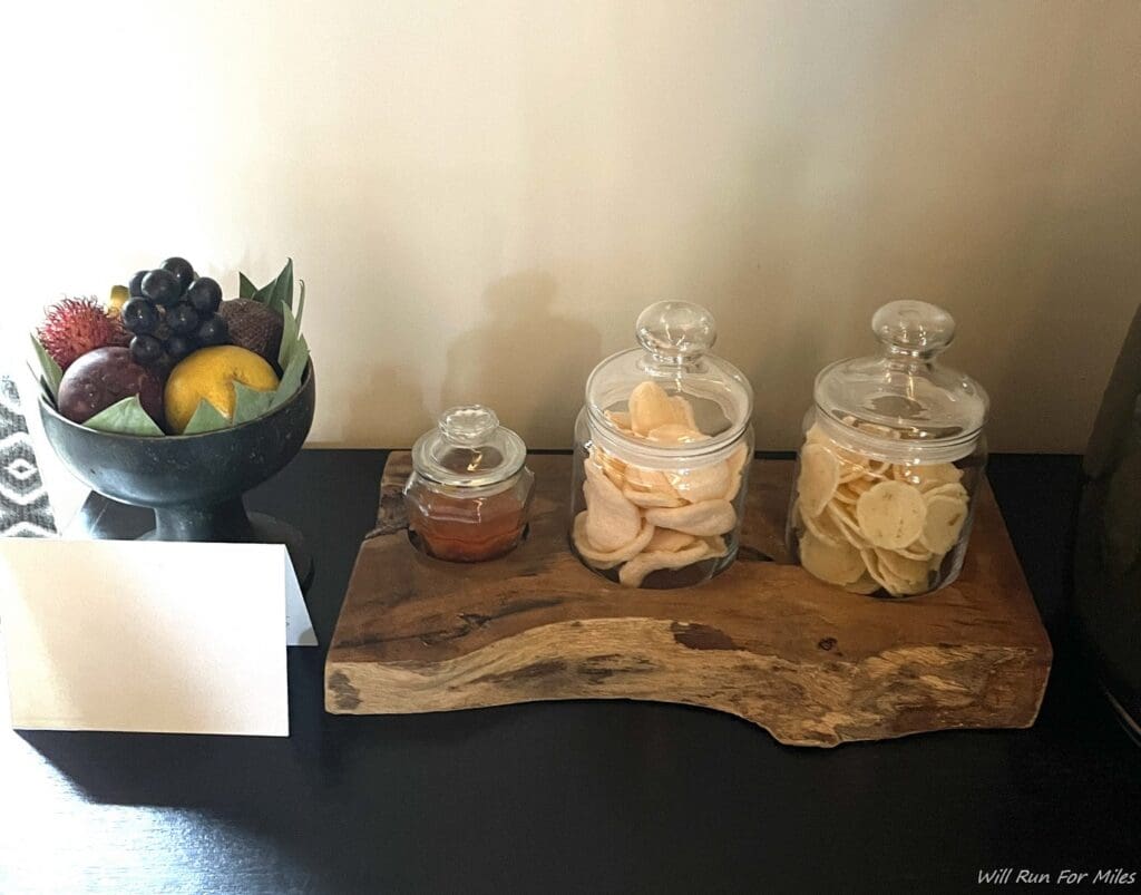 a group of glass jars with food in them on a wood tray