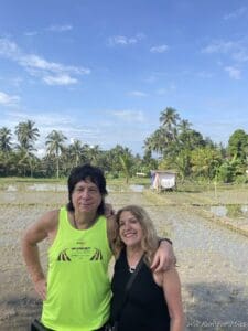 a man and woman standing in a field
