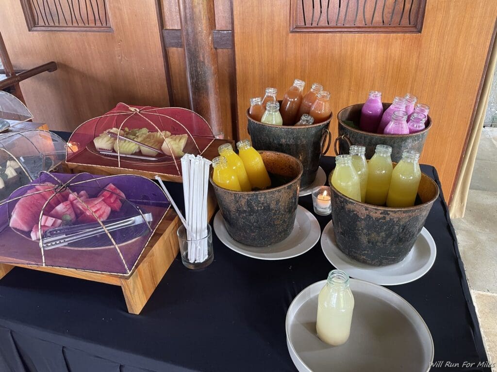 a table with different drinks and plates