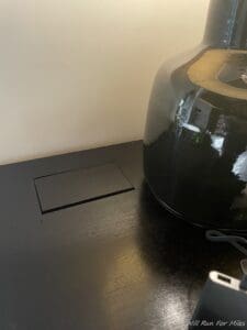 a black vase on a desk