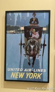 a framed poster of a man and woman in a carriage