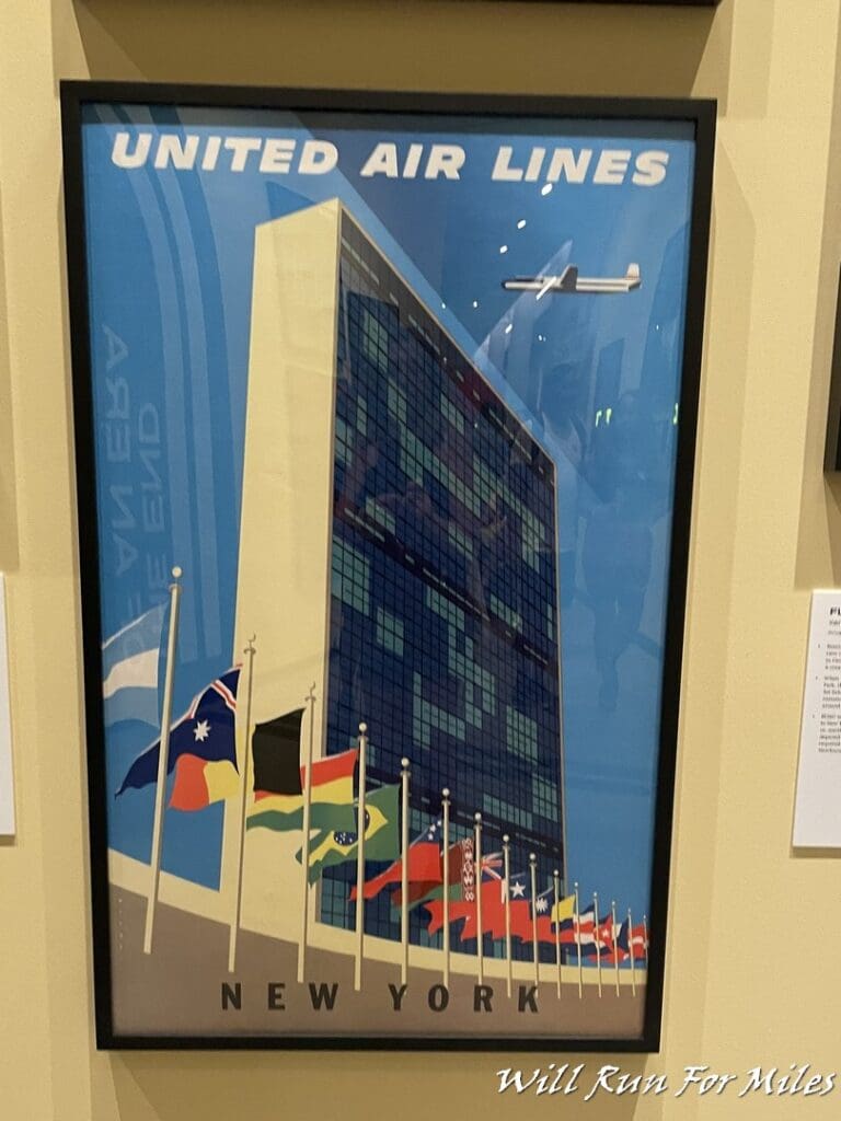 a framed picture of a building with flags