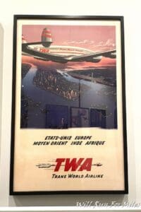a poster of an airplane flying over a river