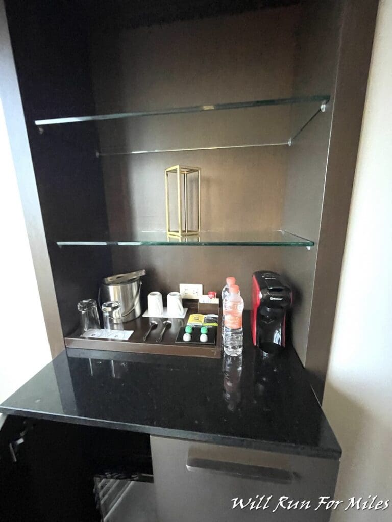 a kitchen counter with glass shelves