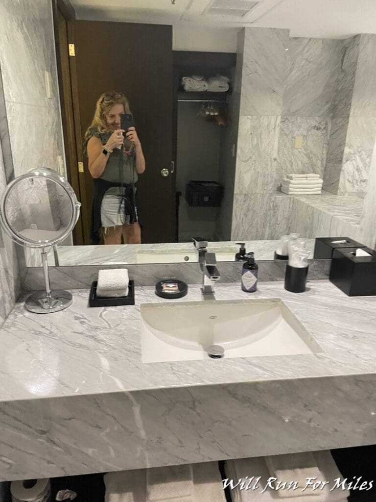 a woman taking a selfie in a bathroom